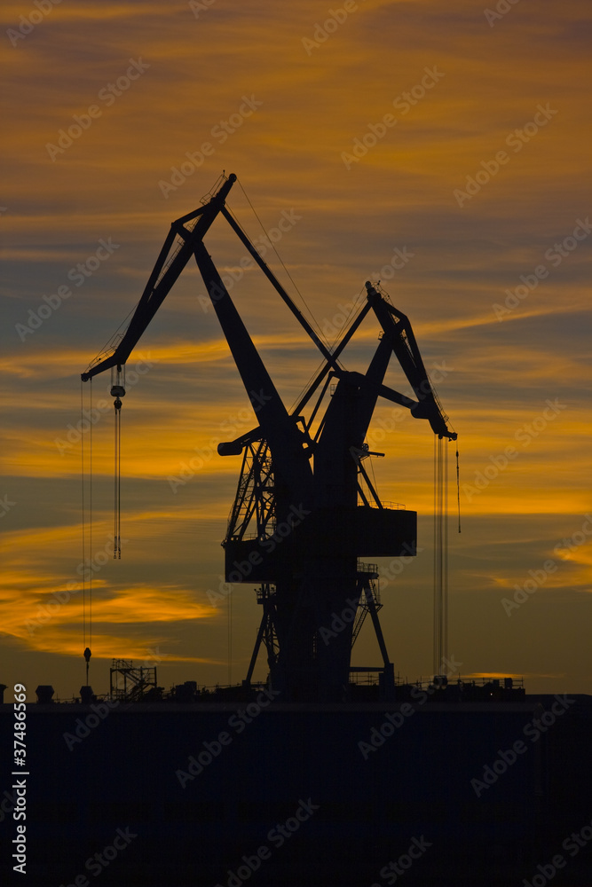 Shipyard cranes in the sunset
