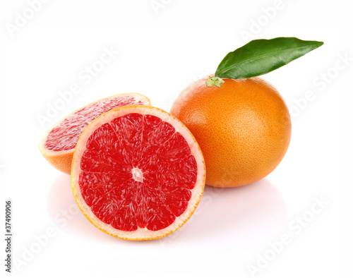 pair ripe juicy grapefruit with green leaf isolated on white
