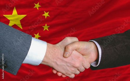 businessmen handshakeafter good deal in front of china flag