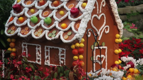 Gingerbread house decorated with fruit and flowers