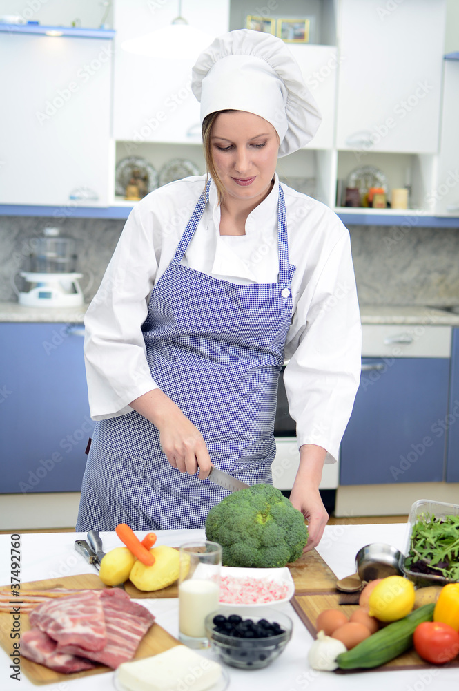 Attractive chief cook preparing food Attractive chief cook preparing food