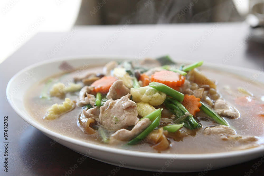 Thai food Wide Noodles in a Creamy Sauce with pork