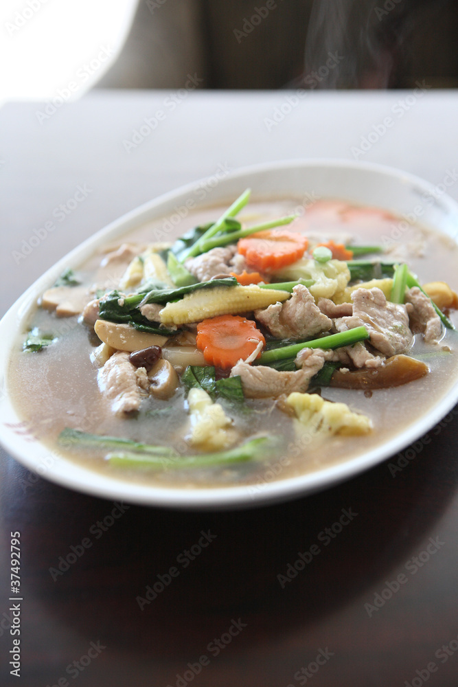 Thai food Wide Noodles in a Creamy Sauce with pork