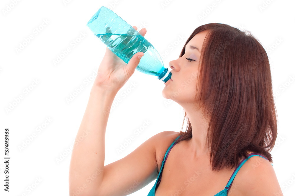 Thirsty young women drinking water after fitness workout Thirsty young women drinking water after fitness workout