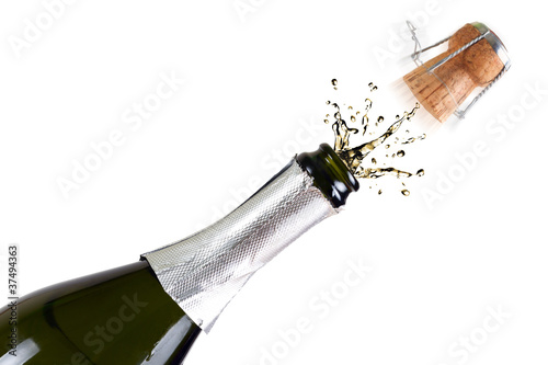Fototapeta Bottle of champagne with splashes over white background