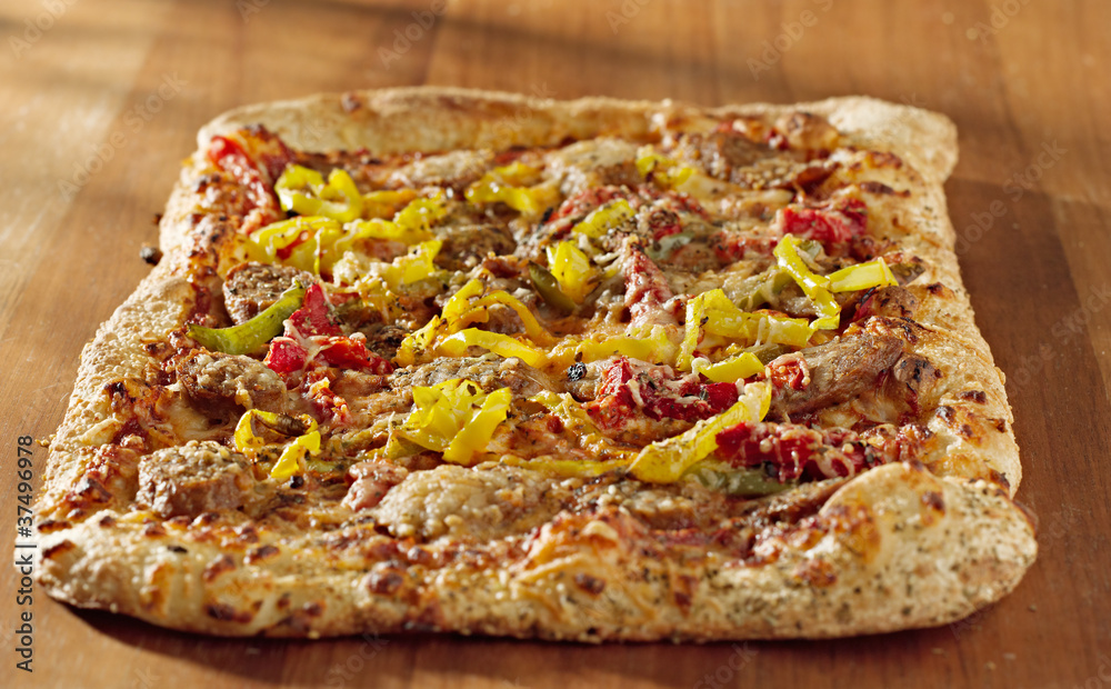 gourmet pizza with sausage and colorful peppers