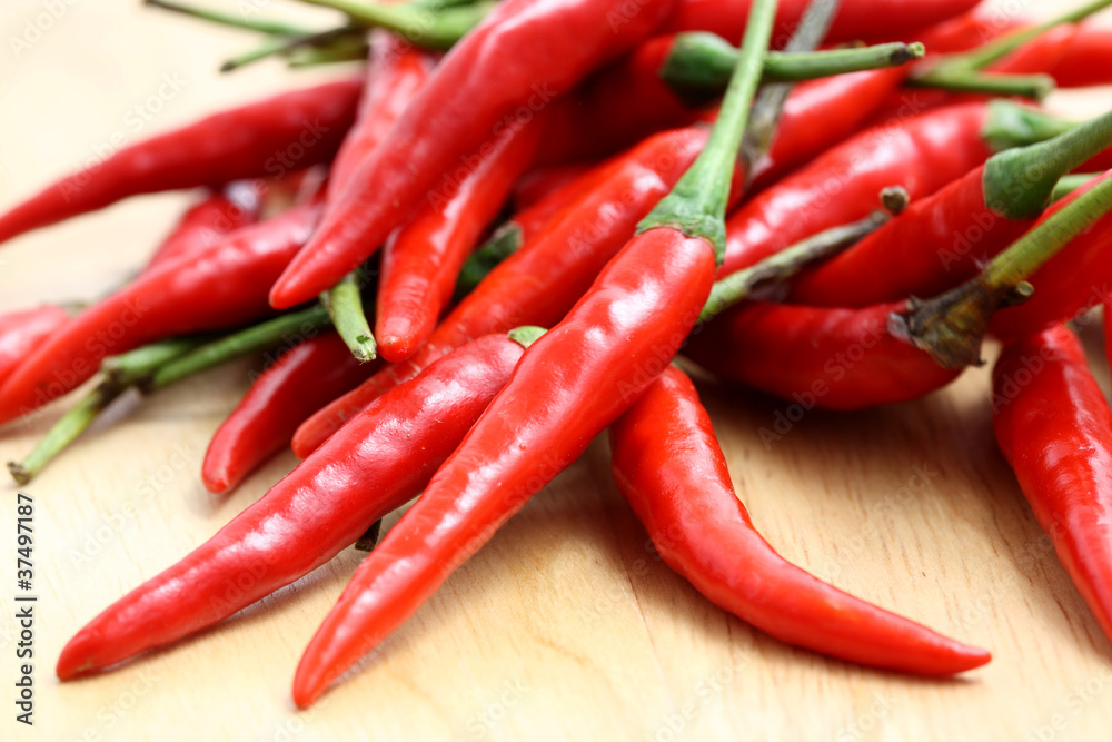 Red hot chili pepper on wood background