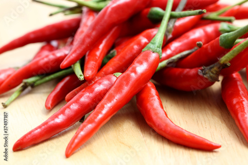 Red hot chili pepper on wood background