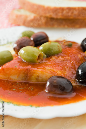 Fish with olives in tomato sauce.