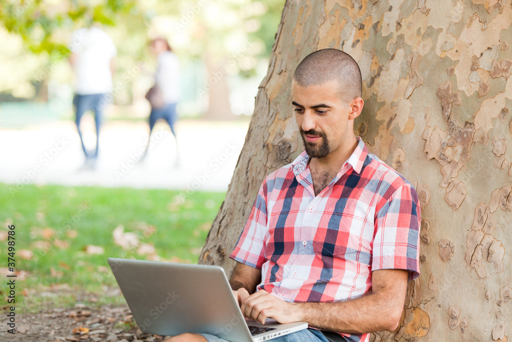Young Man With Computer at Park Young Man With Computer at Park