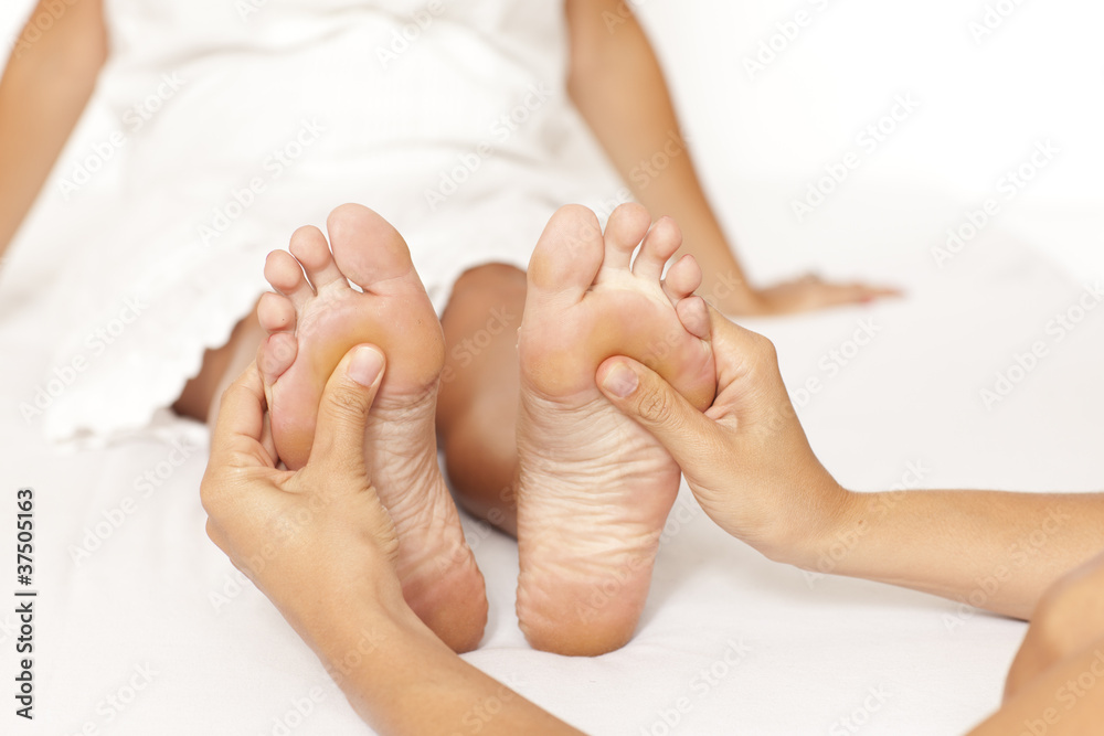 Human hands massaging a woman’s foot