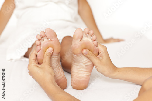 Human hands massaging a woman’s foot © Adam Gregor