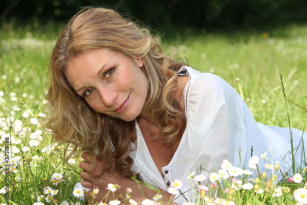 Woman lying in a meadow