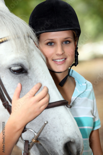 Blond teenage horse rider photo