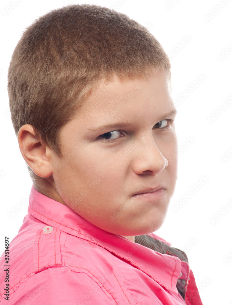 Angry teenage boy looking with hate in his eyes Angry teenage boy looking with hate in his eyes