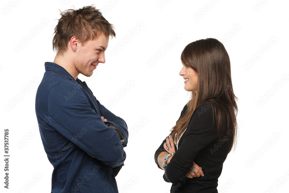Side view o young couple standing face to face Side view o young couple standing face to face