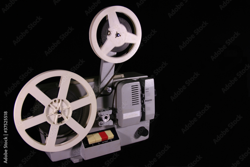 Naklejka premium Old projector on a black background