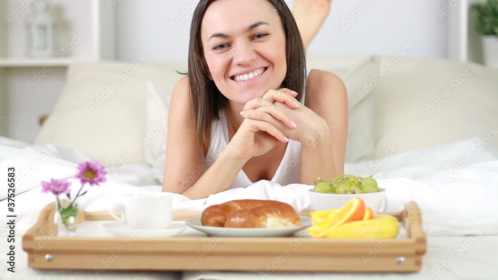 Attractive happy woman with breakfast in bed Attractive happy woman with breakfast in bed