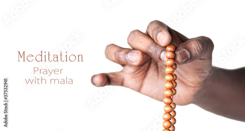 Hand with japa mala beads photo