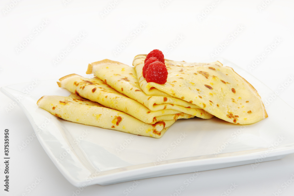 Crepe on a plate with a raspberry