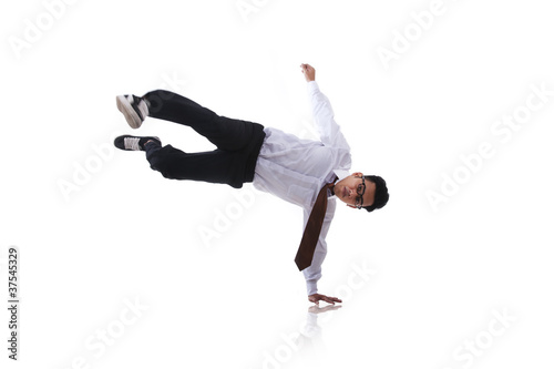 Asian man with acrobatic kick isolated on white