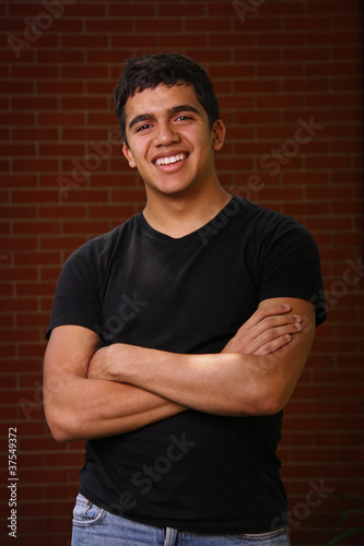 Young teenager smiling with arms crossed