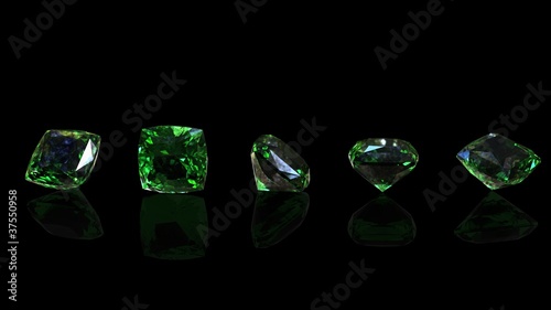 Round gemstone on black background. Emerald. Peridot