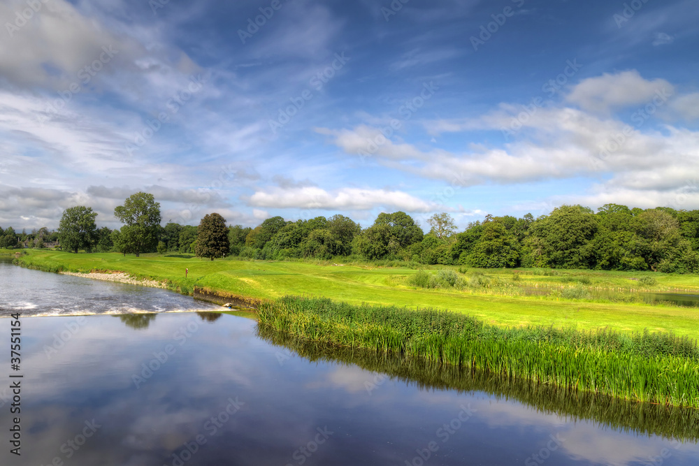 Idyllic golf course with reflection in the river Idyllic golf course with reflection in the river