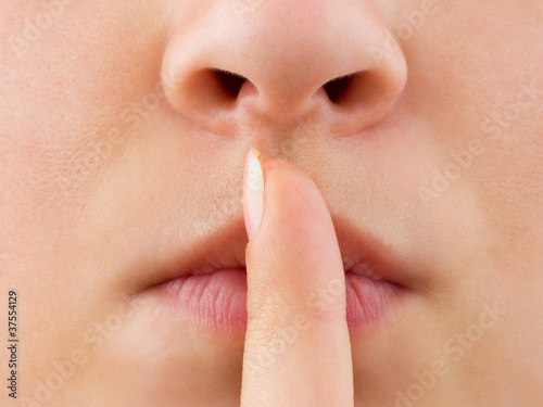 Slika na platnu Woman holding finger to lips