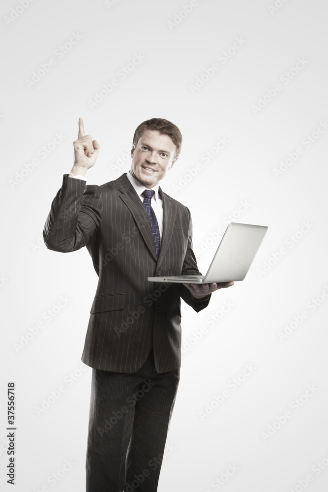 Happy young business man with laptop showing thumbs up Happy young business man with laptop showing thumbs up