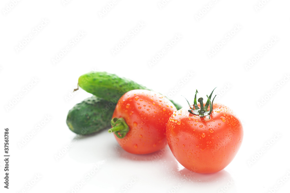 red ripe tomato and cucumber isolated on white