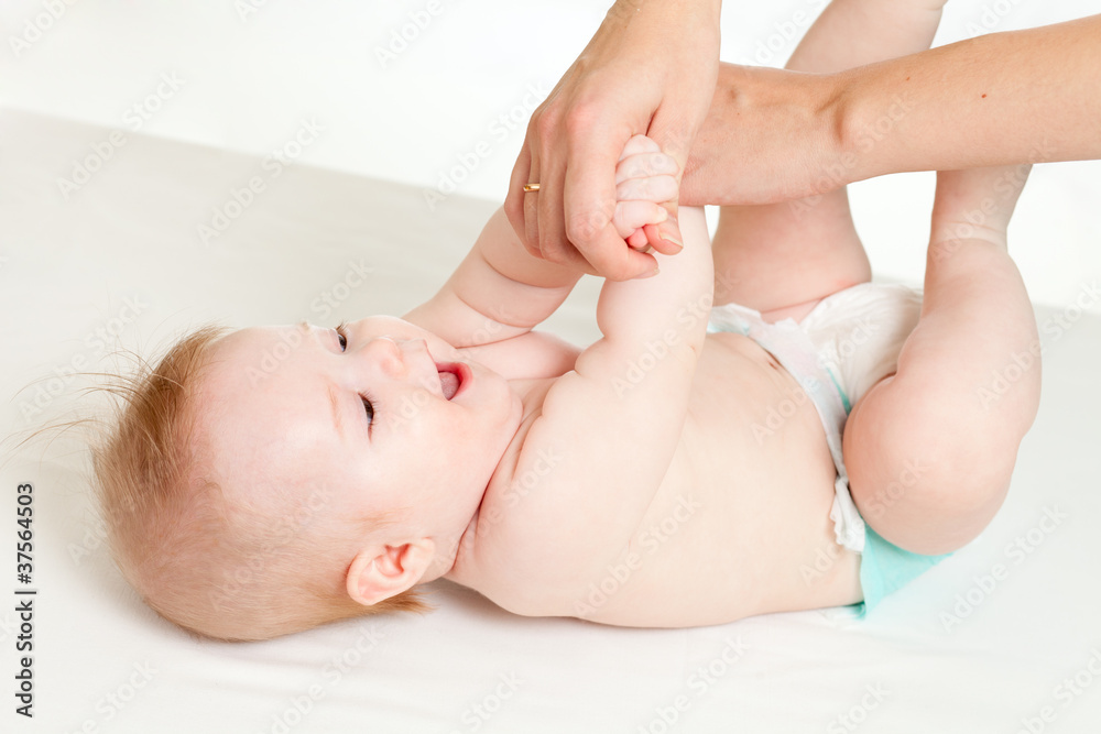 mother massaging her baby girl mother massaging her baby girl