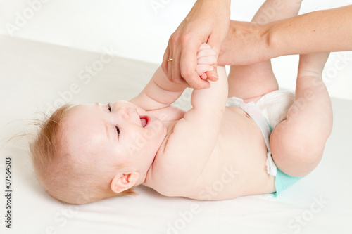 mother massaging her baby girl