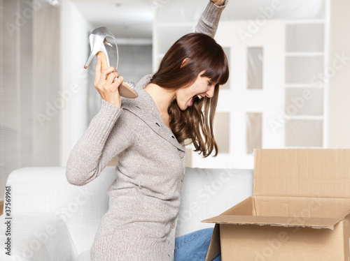 Young Woman opening her mail order / parcel photo