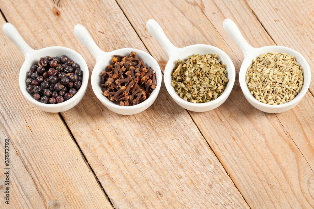 Assorted bowls of spices over wooden table Assorted bowls of spices over wooden table