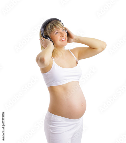 Pregnant woman listening to music, on white background