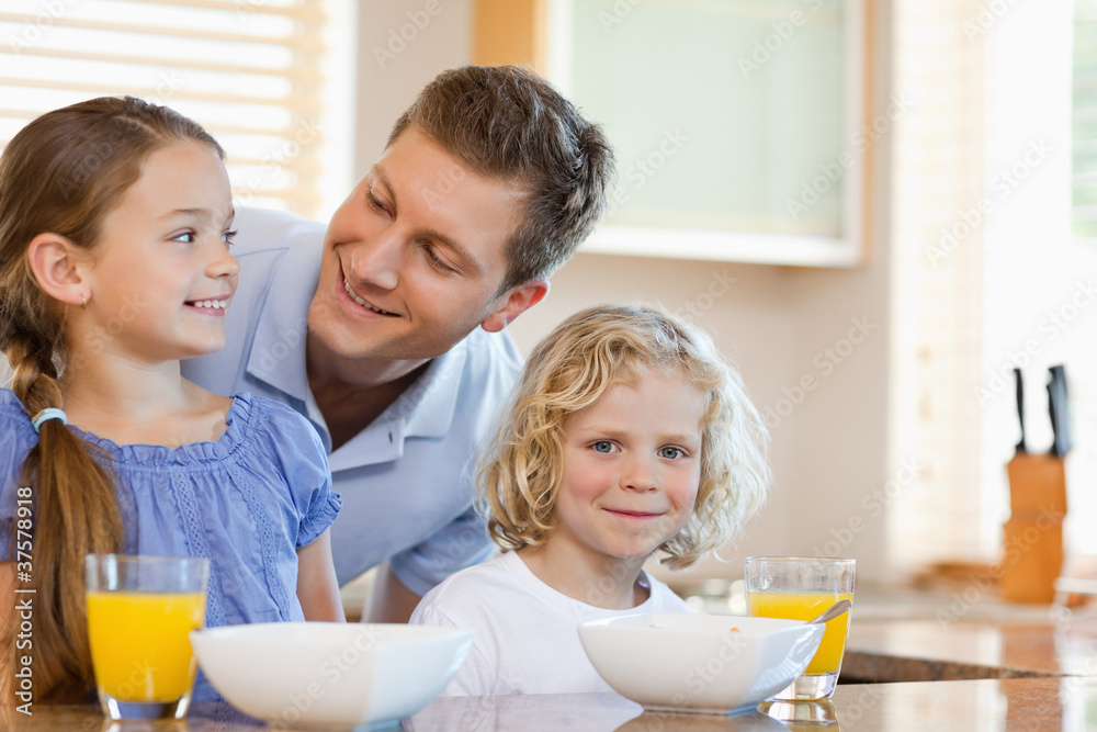 Father with his children behind the kitchen counter Father with his children behind the kitchen counter