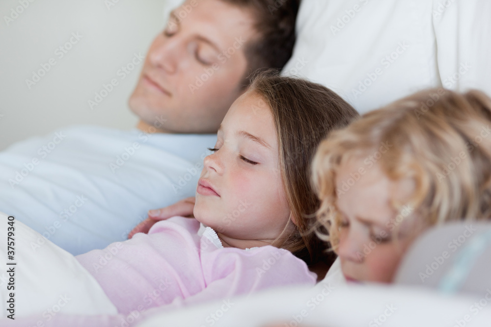 Father taking a nap with his children Father taking a nap with his children