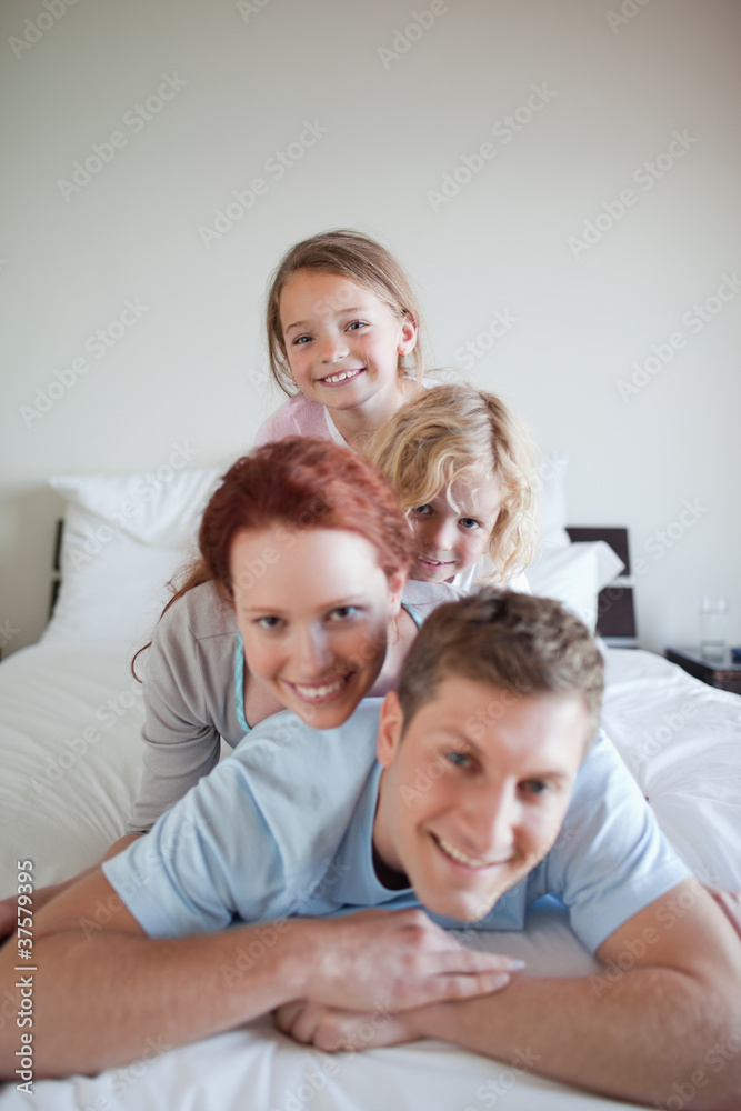 Cheerful family lying on each other