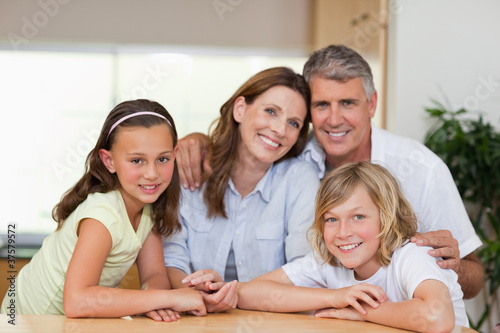 Family together behind table