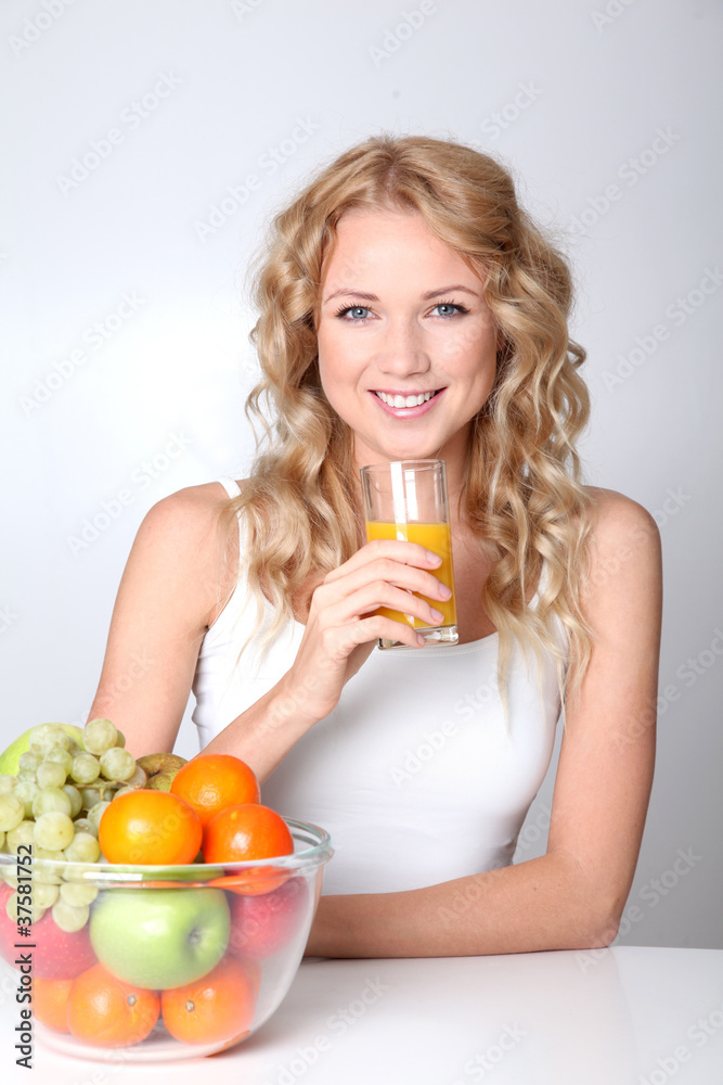 Beautiful blond woman drinking fruit juice Beautiful blond woman drinking fruit juice