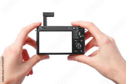 Closeup image of two hands black compact digital photo camera wi