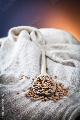 raw lentils over spoon and woolen