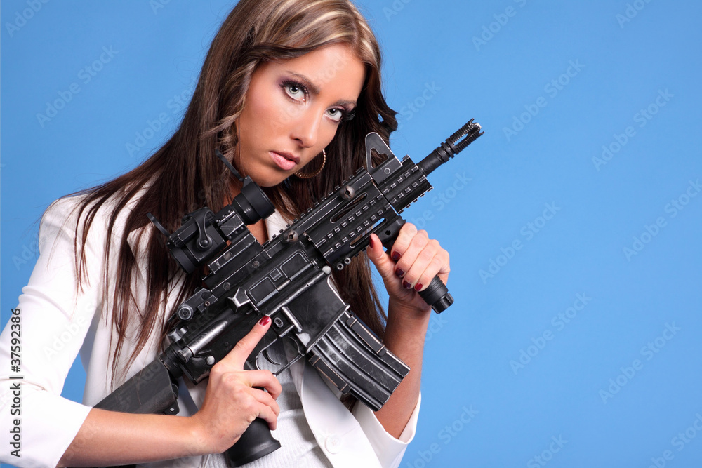 Beautiful woman holding an automatic rifle.