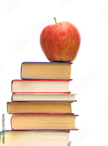 red apple on pile of books