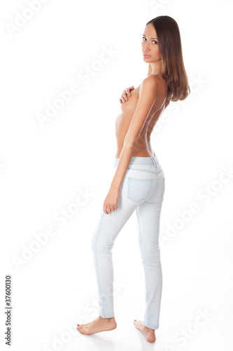 young sexy woman in blue jeans on a white background