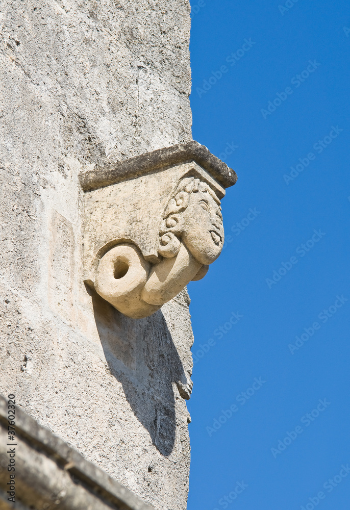 Stone face on wall.