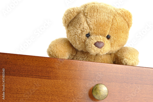 Teddy bear in a wooden drawer photo