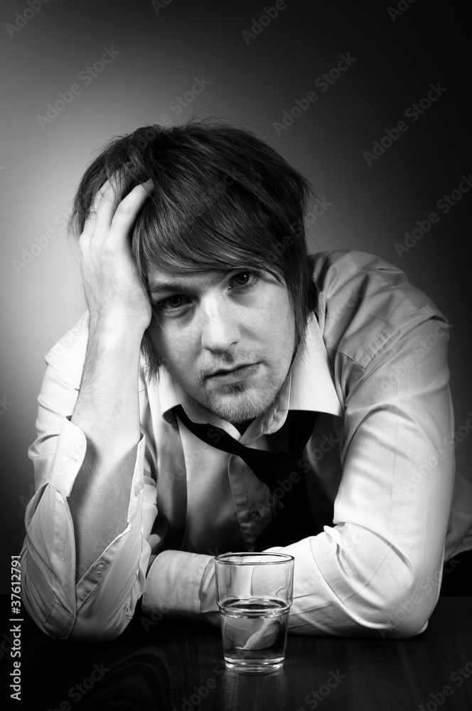 A depressed young man with alcohol A depressed young man with alcohol