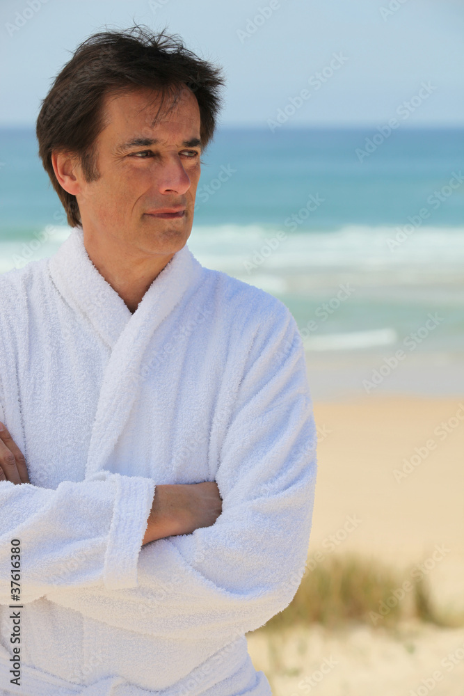 Man standing with arms crossed in the sand dunes